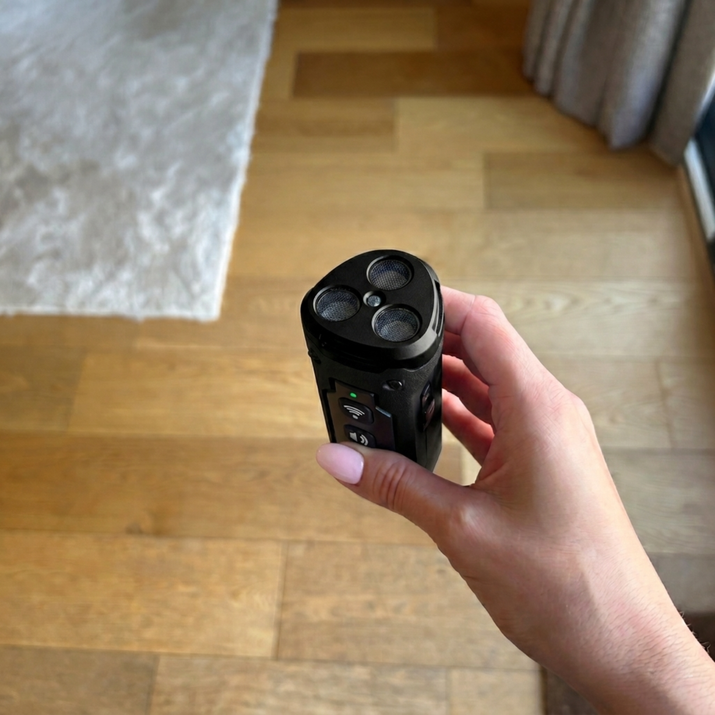 Hand holding a black barking tool