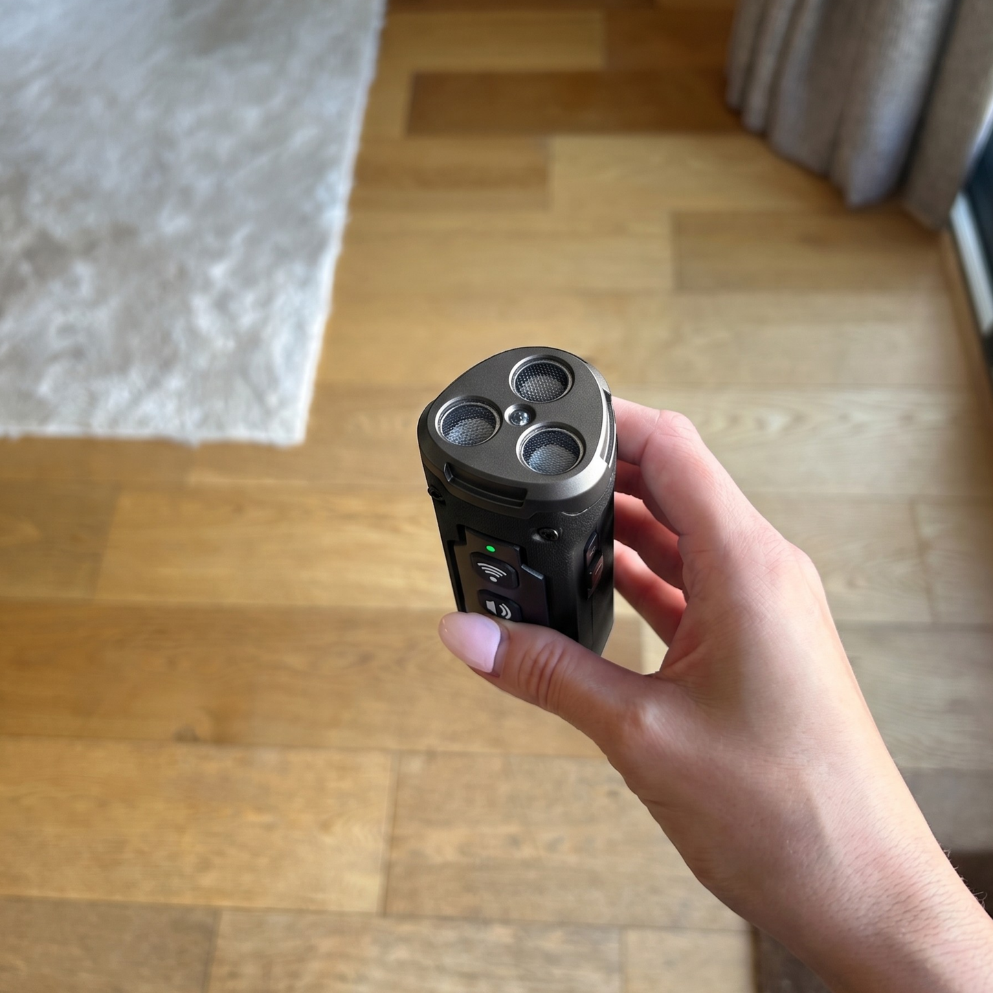 Hand holding a black barking tool